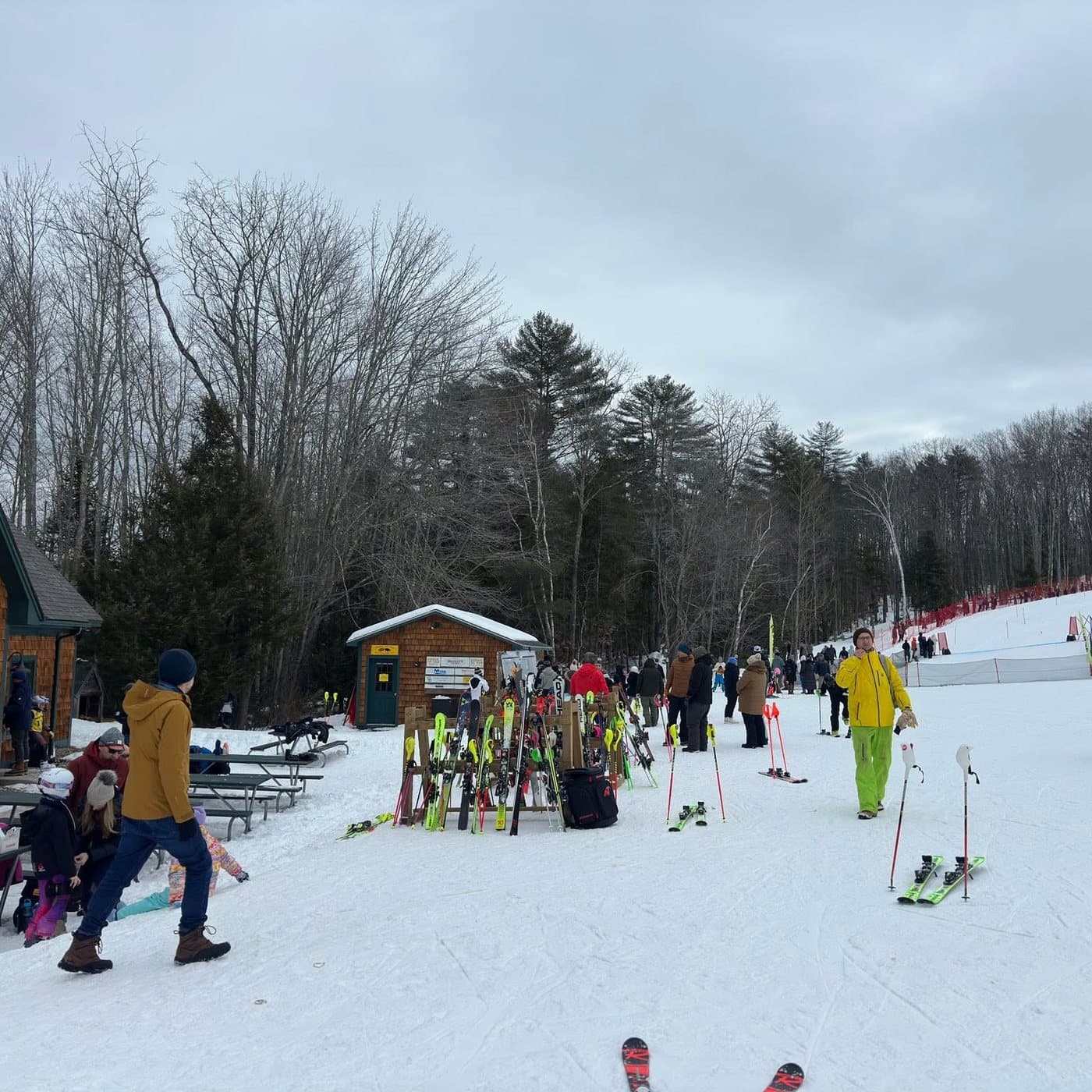 Families and ski racks outside the base lodge at Abenaki on a busy afternoon