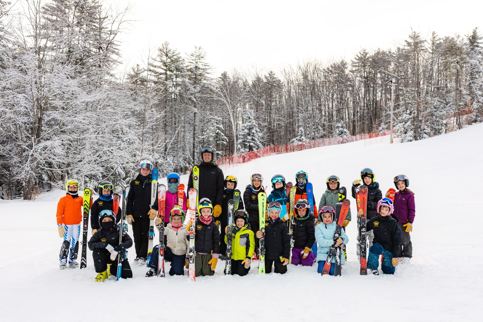 The U10 group and their coaches on the slope at Abenaki