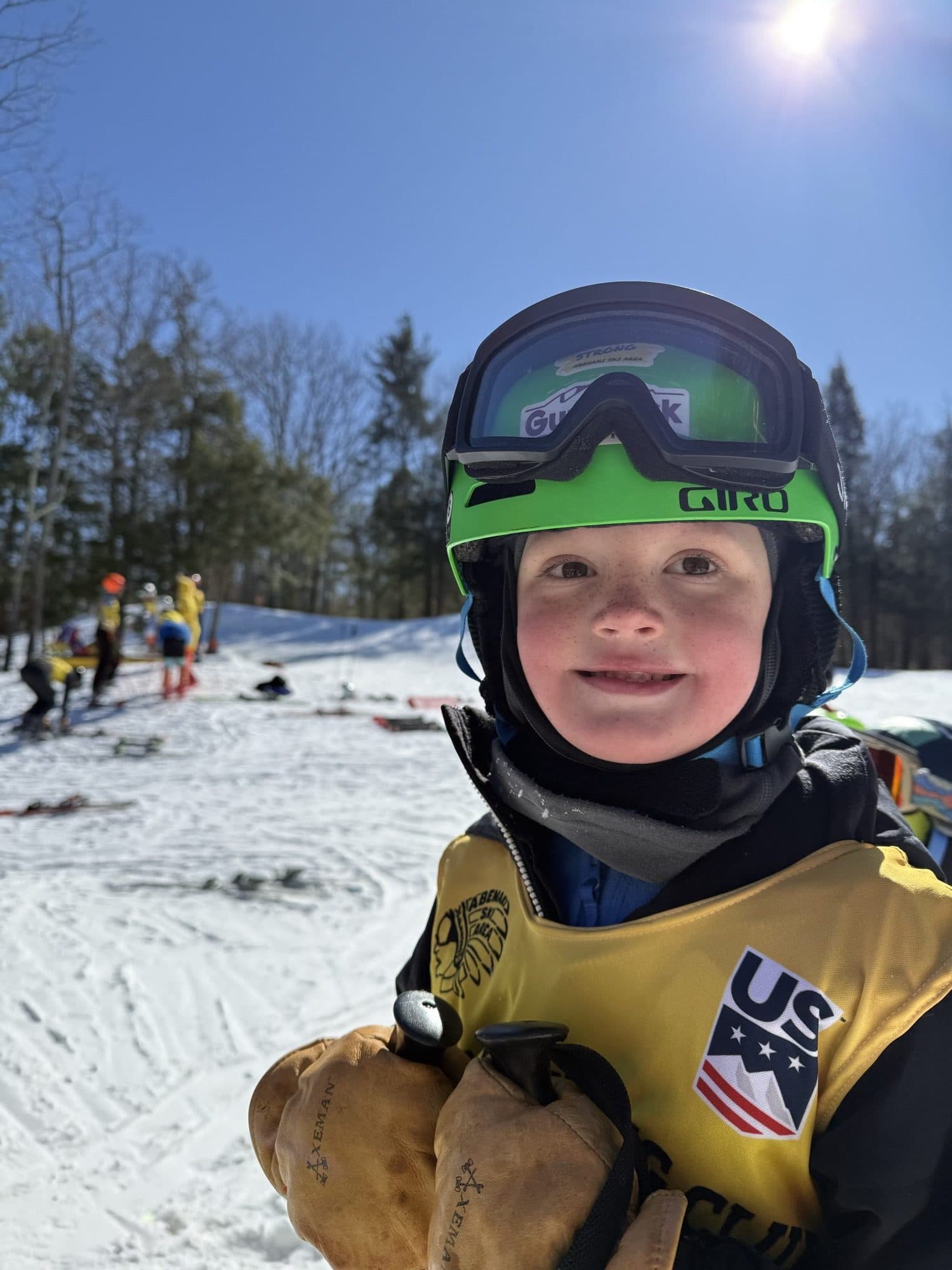 A young Abenaki racer in goggles and a race bib
