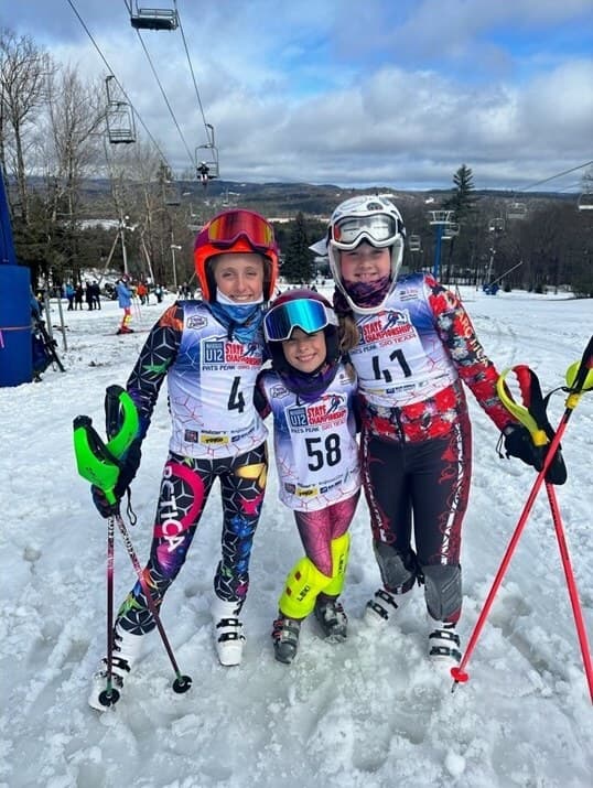 Three U12 racers in their bibs at the state championship at Pats Peak
