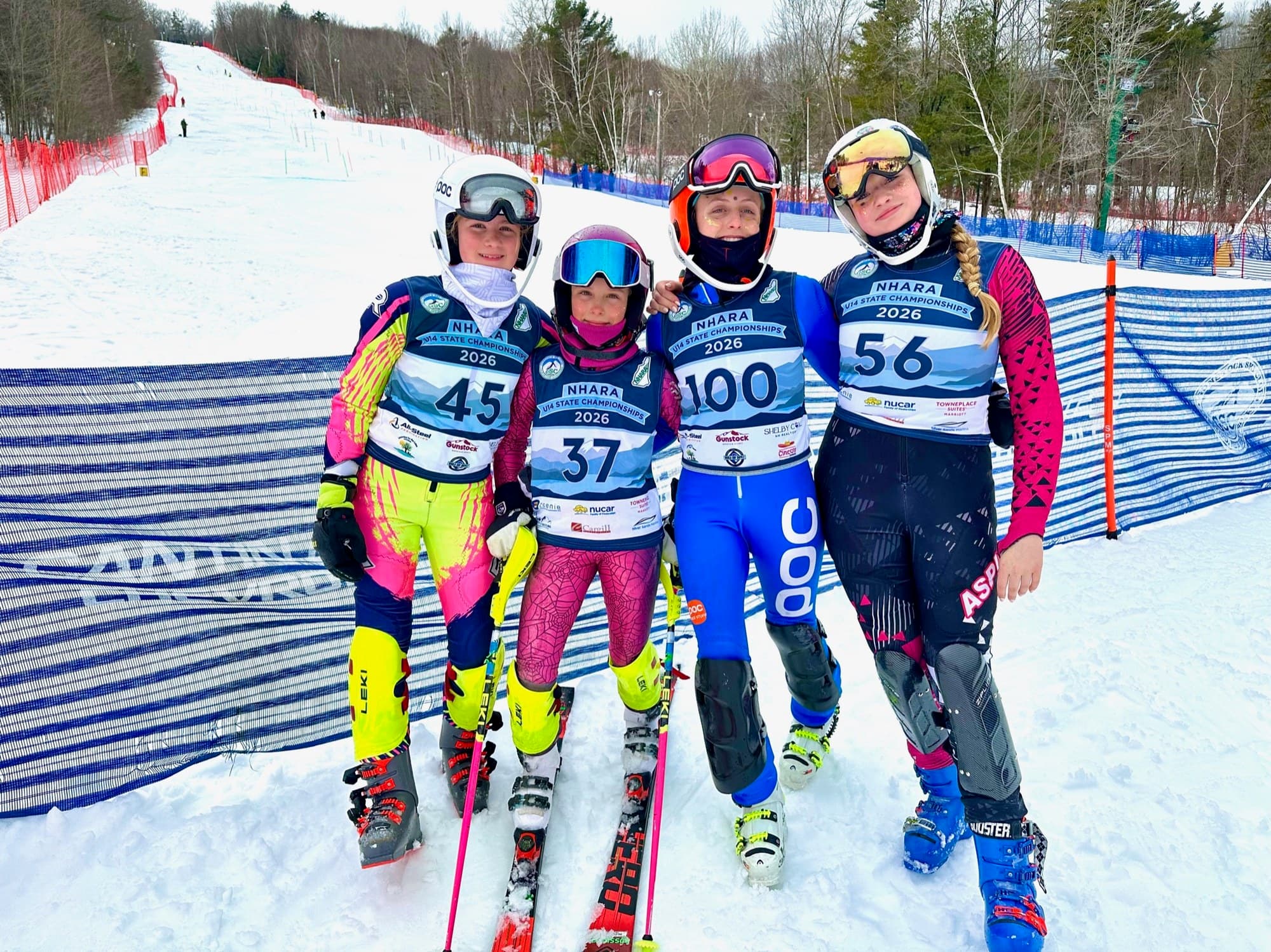 Four U14 racers in NHARA state championship bibs at the bottom of the course